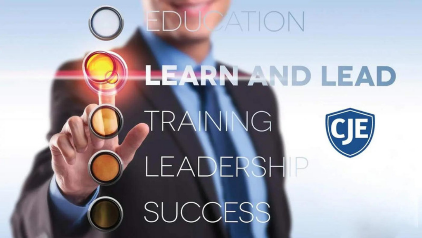 A man in business attire pointing to the words " learn and lead ".